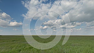 Russia, timelapse. The movement of clouds over the fields of winter wheat in early spring in the vast steppes of the Don.