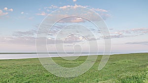 Russia, timelapse. The movement of clouds over the fields of winter wheat in early spring in the vast steppes of the Don.