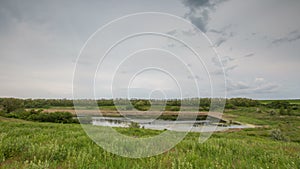 Russia, timelapse. The movement of the thunderclouds over the fields of winter wheat in early spring in the vast steppes of the Do