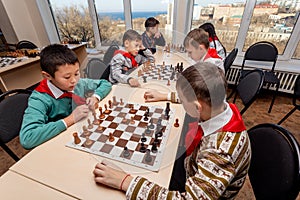 Russia, Vladivostok, 12/01/2018. Kids play chess during chess competition in chess club. Education, chess and mind games.