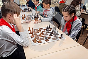 Russia, Vladivostok, 12/01/2018. Kids play chess during chess competition in chess club. Education, chess and mind games.