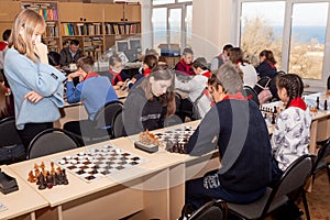 Russia, Vladivostok, 12/01/2018. Kids play chess during chess competition in chess club. Education, chess and mind games.