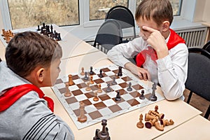 Russia, Vladivostok, 12/01/2018. Kids play chess during chess competition in chess club. Education, chess and mind games.