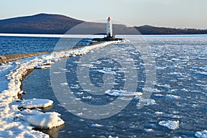 Russia. Vladivostok. The lighthouse of Egersheld1876 year built Tokarevskaya koshka in winter evening in Amur bay