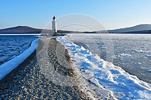 Russia. Vladivostok. The lighthouse of Egersheld1876 year built Tokarevskaya koshka in winter evening in Amur bay