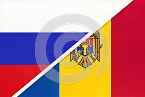 Russia vs Moldova national flag from textile. Relationship and partnership between two countries