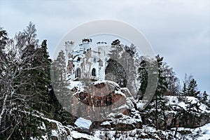 Russia, Vyborg, January 2021. The building of an abandoned chapel in the old park on the rock.