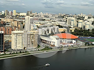 Russia, Yekaterinburg, Olympic embankment, Iset River. Urban landscape view from above. High-rise buildings and the river bank.