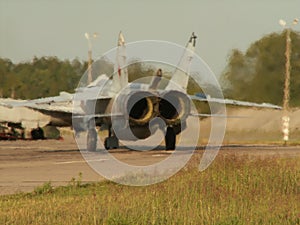 Russian aircraft Sukhoi Su-24 running on the takeoff strip. Rear jet engines view
