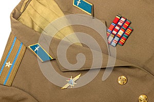 Russian army epaulettes and decorations on green uniform, top view