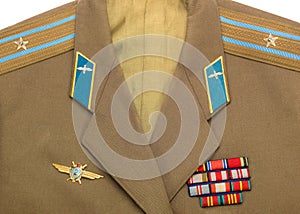 Russian army epaulettes and decorations on green uniform, top view