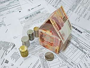 Russian banknotes and coins on the background of the payment documents
