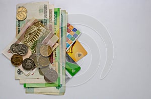 Russian banknotes, coins and Bank cards are on a white background. Close up