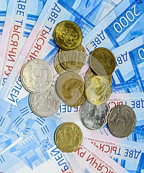 Russian banknotes and coins. A of coins on new Russian banknotes in denominations of 2000 and 200 rubles