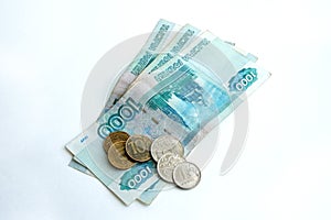 Russian banknotes and coins on a white background