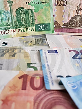 Russian banknotes and euro bills of different denominations, background and texture