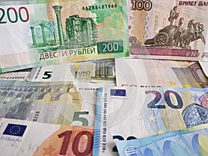 Russian banknotes and euro bills of different denominations, background and texture