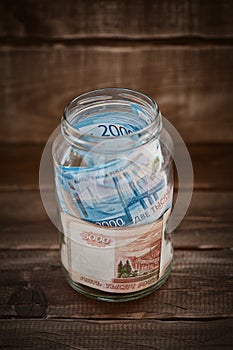 Russian banknotes in a glass jar