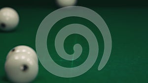 Russian billiards. The white ball hits another. The balls fly in different directions