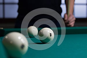 Russian billiards white balls on green table cloth and player
