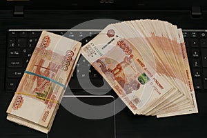 Russian bills are on the laptop keyboard