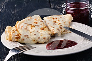 Russian blini pancakes and berry jam. Maslenitsa is an Eastern S