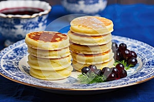 russian blinis stacked on a blue plate