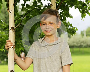 Russian boy in a birch grove