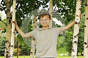 Russian boy in a birch grove