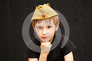 Russian boy in a military cap of World War II.
