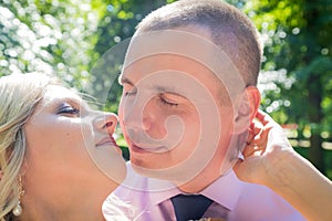 Russian bride and groom together in green city park