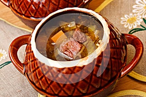 Russian cabbage soup in ceramics pot