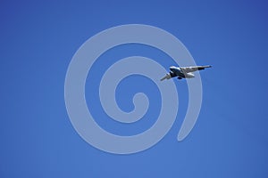 Russian cargo plane comes in for landing, against the blue sky