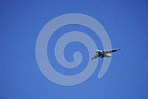 Russian cargo plane comes in for landing, against the blue sky