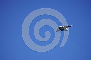 Russian cargo plane comes in for landing, against the blue sky
