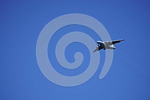 Russian cargo plane comes in for landing, against the blue sky