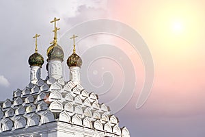 Russian Christian Orthodox church with domes and a cross against the sky. Russian Orthodoxy and Christian Faith concept.