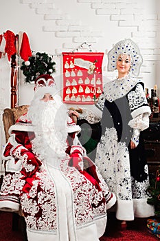 Russian Christmas characters: Ded Moroz, Santa and Snegurochka, snow girl posing in the studio