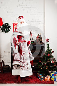 Russian Christmas characters: Ded Moroz, Santa and Snegurochka, snow girl posing in the studio