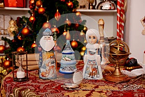 Russian Christmas figurine on the table in decorated room