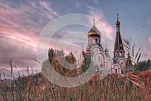 Russian church building in pink sunrise colours