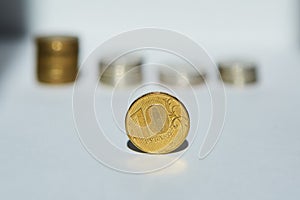 Russian coins with a face value of 10 and others in a stack lie on the white surface of the Concept of economy