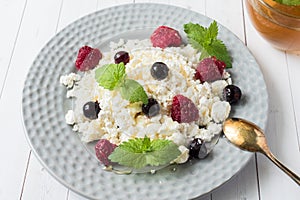 Russian cottage cheese with berries, honey mint, selective focus, healthy Breakfast