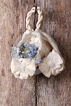 Russian decor: baby bast shoes with flowers forget-me-not
