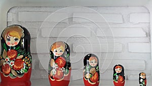 Russian dolls with white brick wall