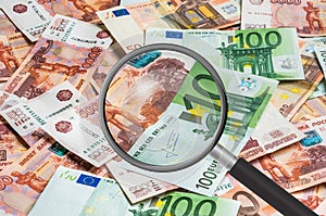 Russian and european money background with magnifying glass