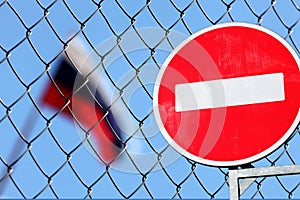 Russian flag behind a metal fence