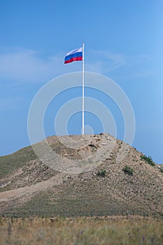 Russian flag on a high hill