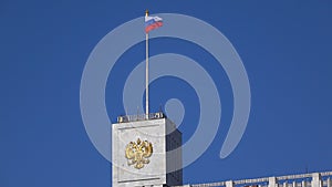 Russian flag and Russian state emblem above government White house in Moscow, 4K