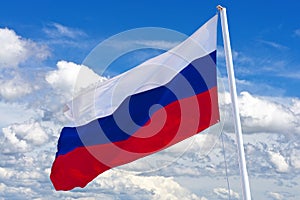 Russian flag waving in the wind over blue sky